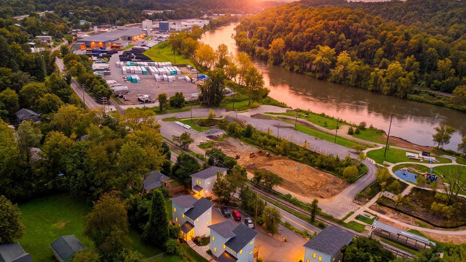 Sunset aerial view of the home near the river.