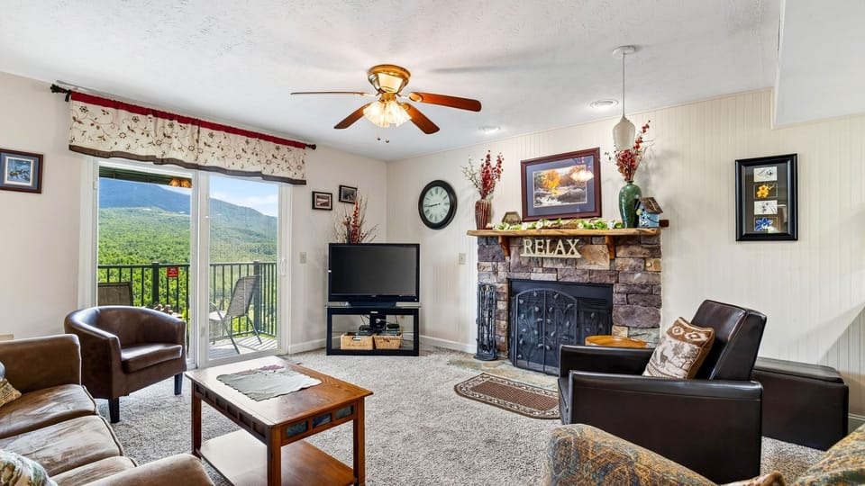 Cozy up by the stone fireplace, then step onto the balcony to take in sweeping mountain views.