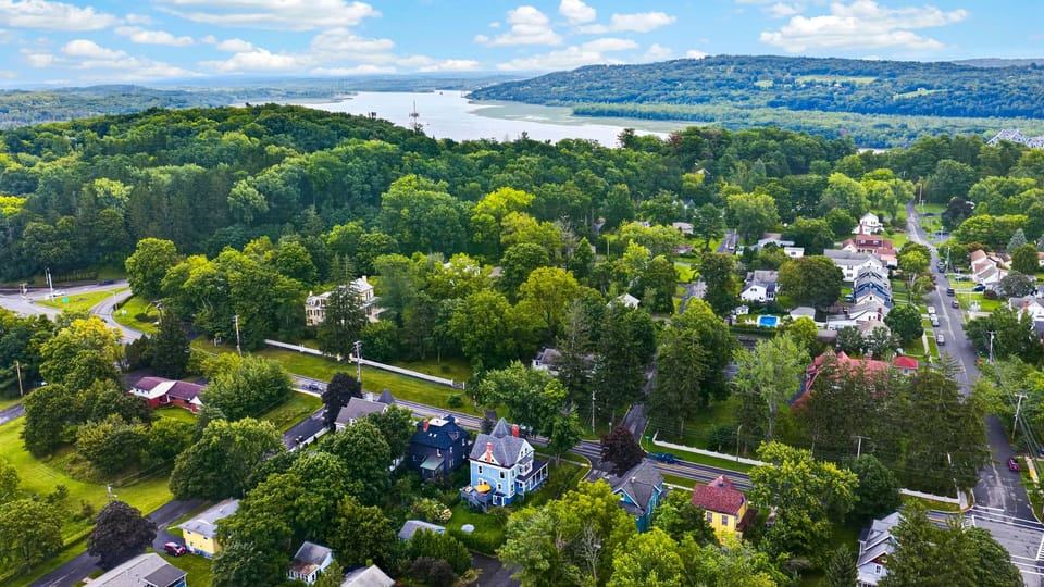Scenic aerial shot highlighting the sprawling green landscape and surrounding hillsides.