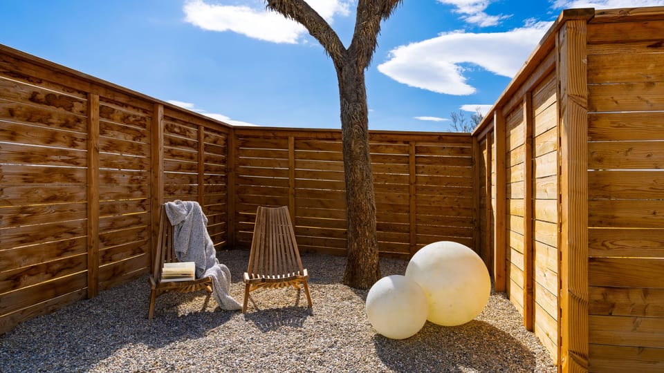 Covered outdoor dining area overlooking the pool.