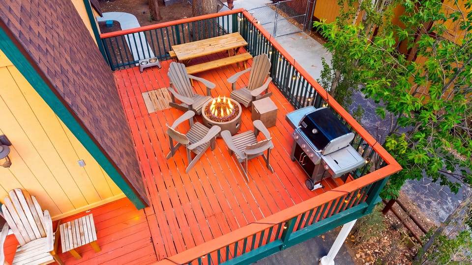 Cozy deck evenings come with Adirondack seating, a glowing firepit, and peaceful forest surroundings.