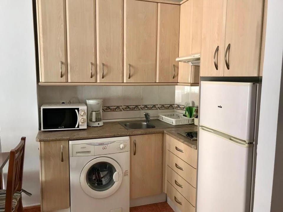 Kitchen or kitchenette, stove, washing machine