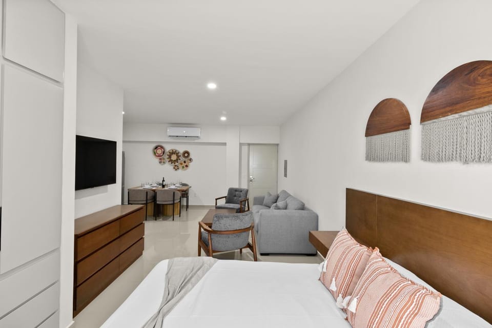 Bed, TV and multimedia, Living room, Seating area, Bedroom, hair dresser