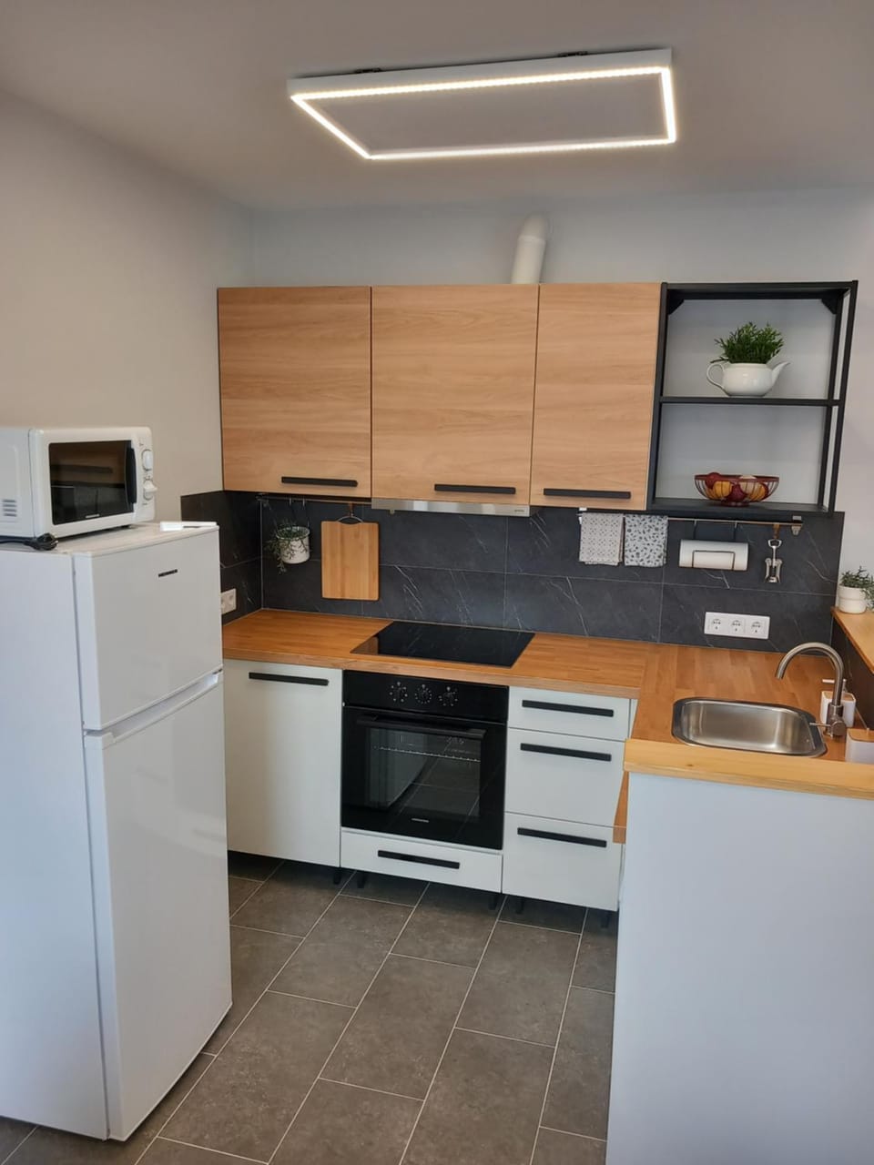 Kitchen or kitchenette, dishwasher, microwave, oven, stove