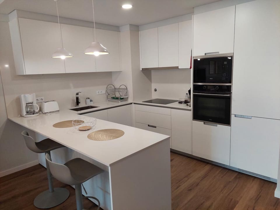 Kitchen or kitchenette, dishwasher, oven, stove, toaster