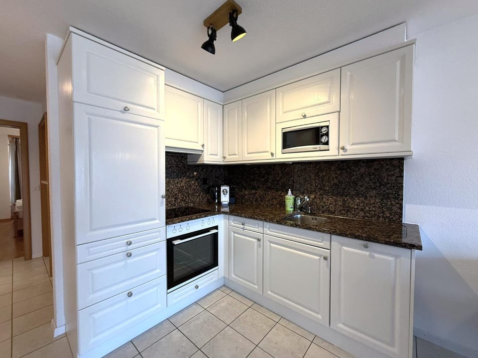 Kitchen or kitchenette, dishwasher, oven, stove