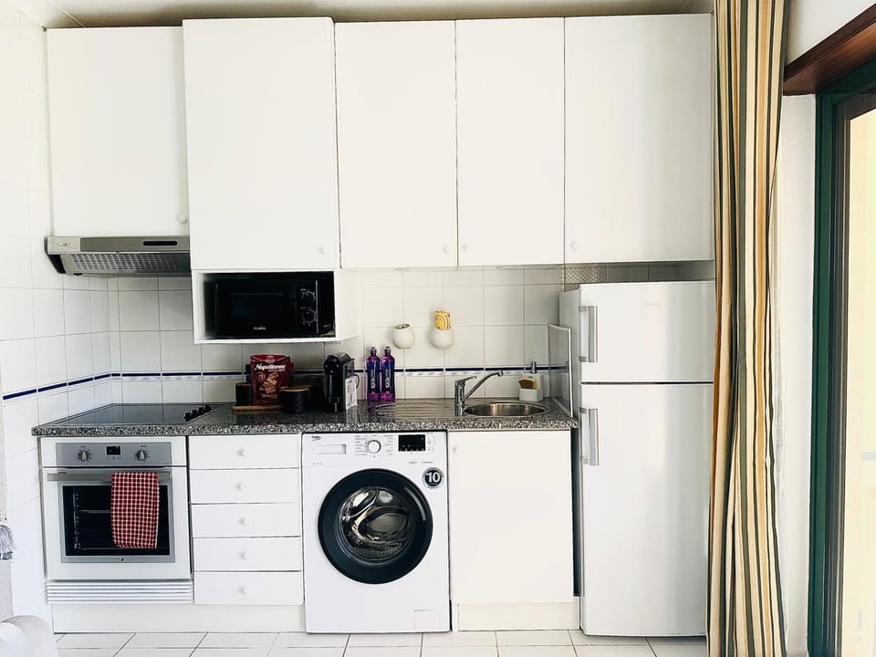 Kitchen or kitchenette, oven, stove, washing machine