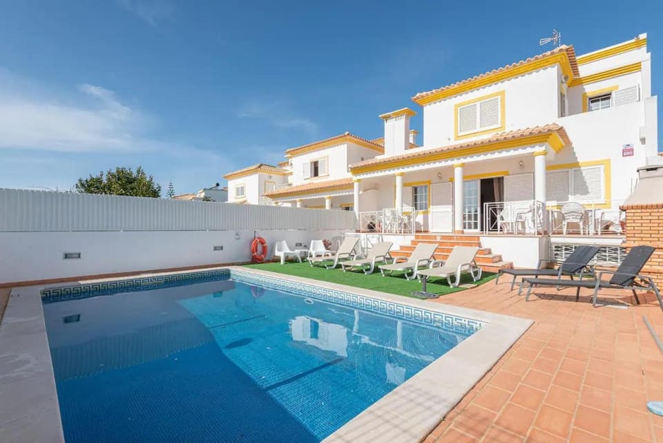 Property building, Patio, Pool view, Swimming pool, sunbed