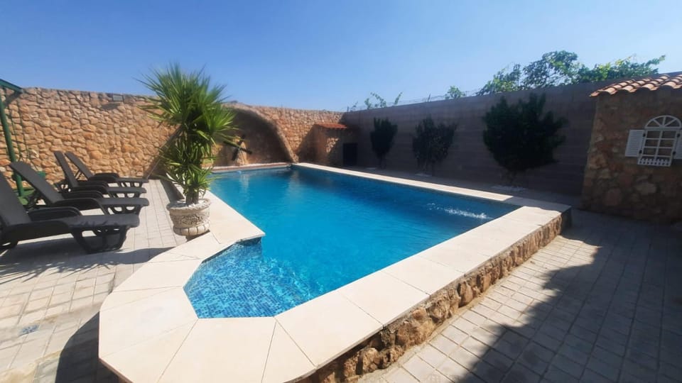 Patio, Day, Natural landscape, Pool view, Swimming pool, sunbed