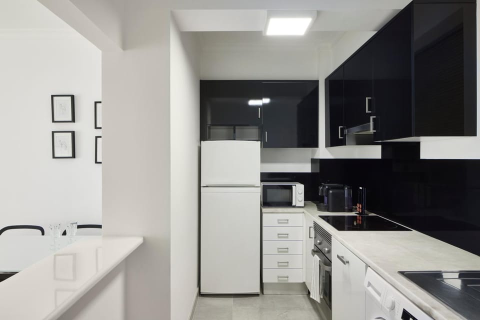 Kitchen or kitchenette, dishwasher, oven, stove, washing machine