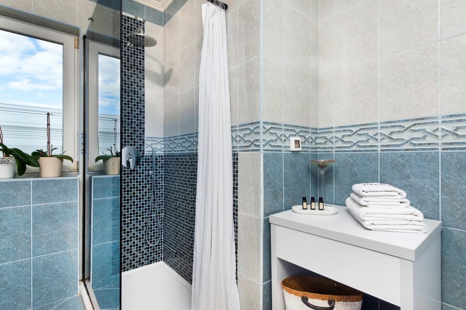 Shower, Bathroom, flat iron, hair dryier, towels