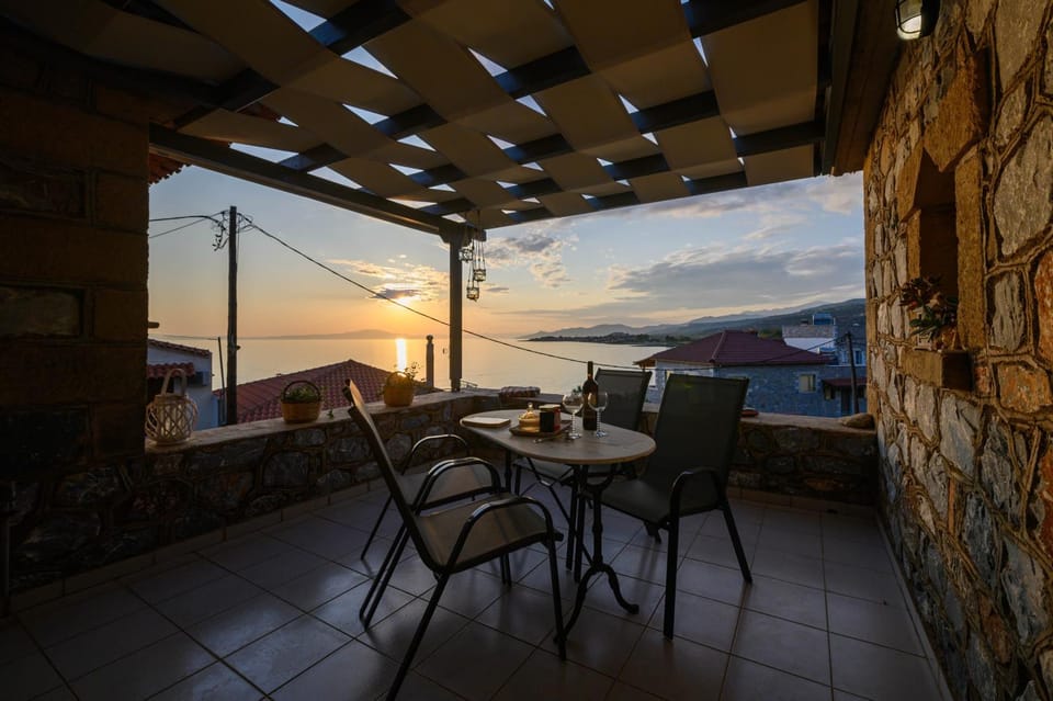 Property building, Patio, Day, Natural landscape, View (from property/room), Balcony/Terrace, Balcony/Terrace, Seating area, On site, Guests, Mountain view, Sea view, Drinks, Alcoholic drinks, Sunset, young children, group of guests