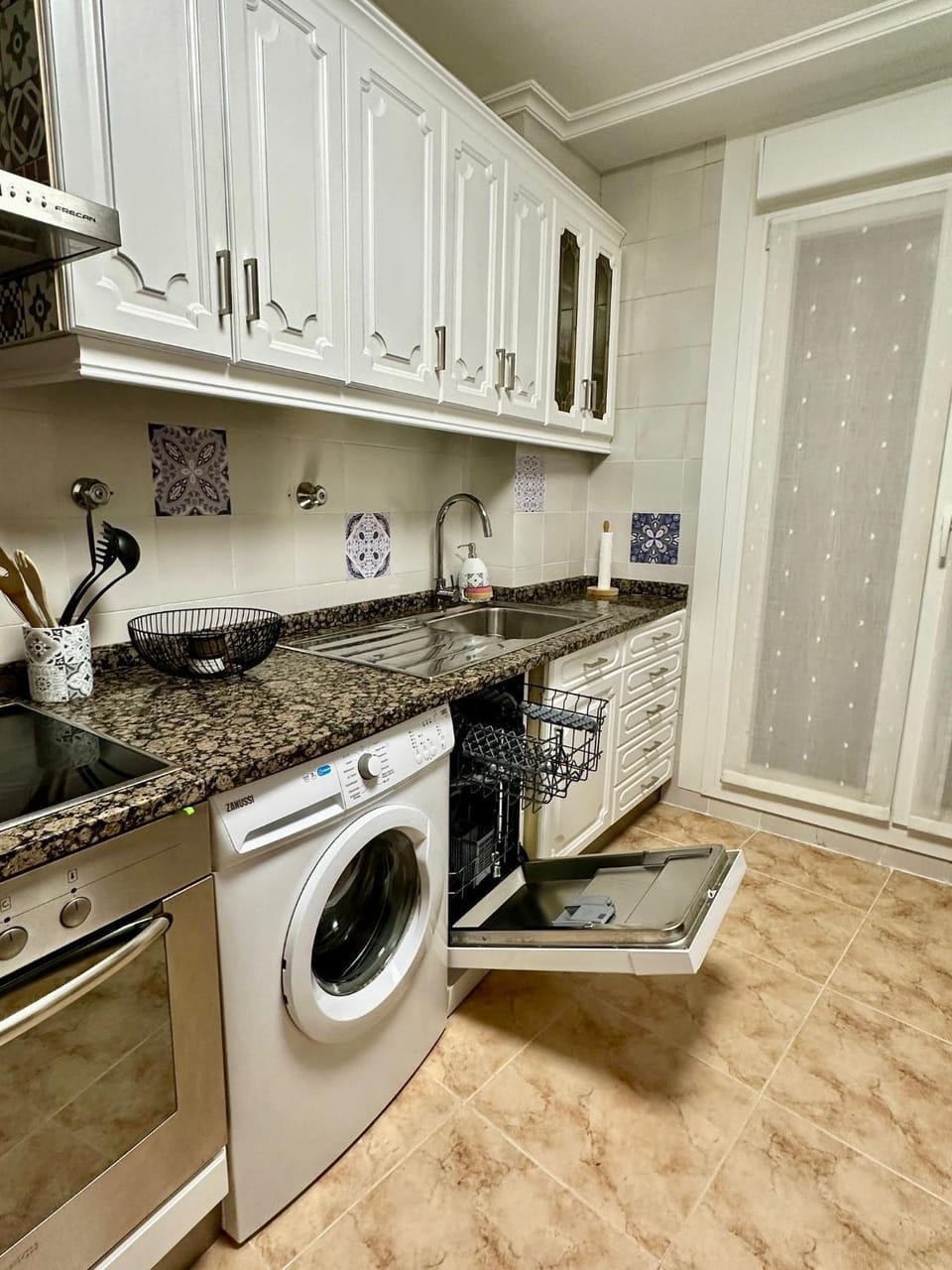 Kitchen or kitchenette, dishwasher, stove, washing machine