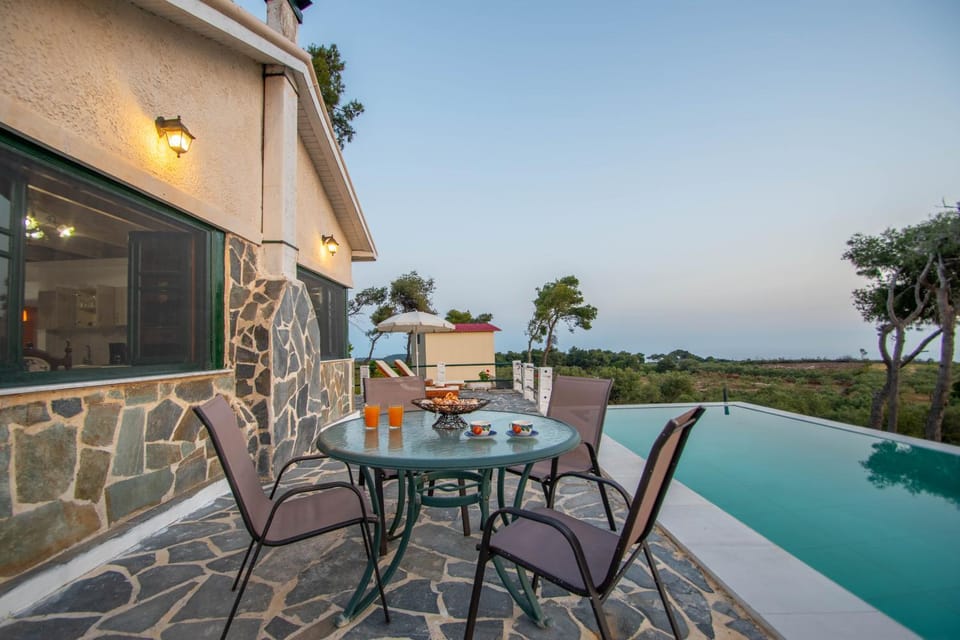 Property building, Patio, Natural landscape, View (from property/room), Seating area, Dining area, Pool view, Sea view, Swimming pool, sunbed