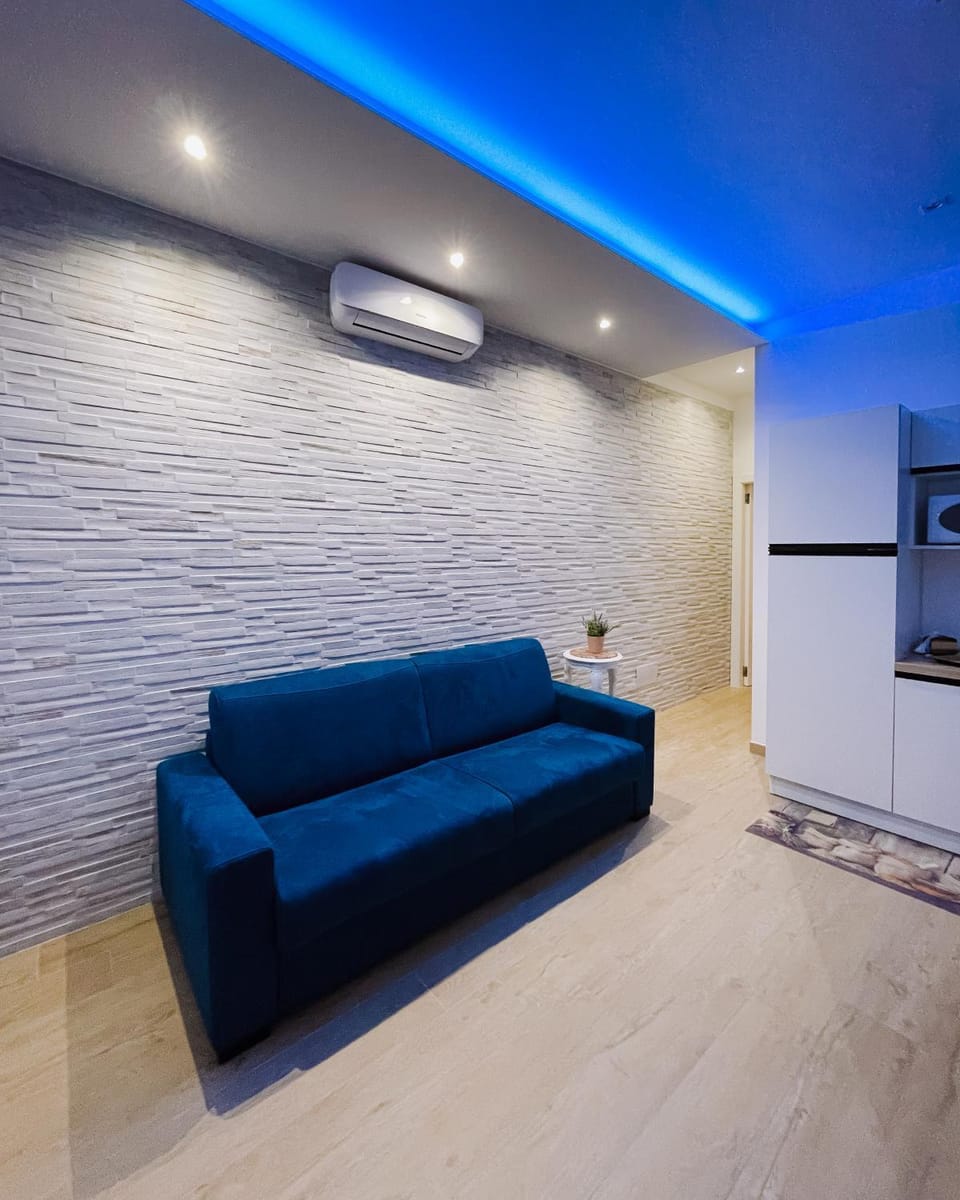 Communal lounge/ TV room, Bed, Living room, Seating area, air conditioner, air conditioner