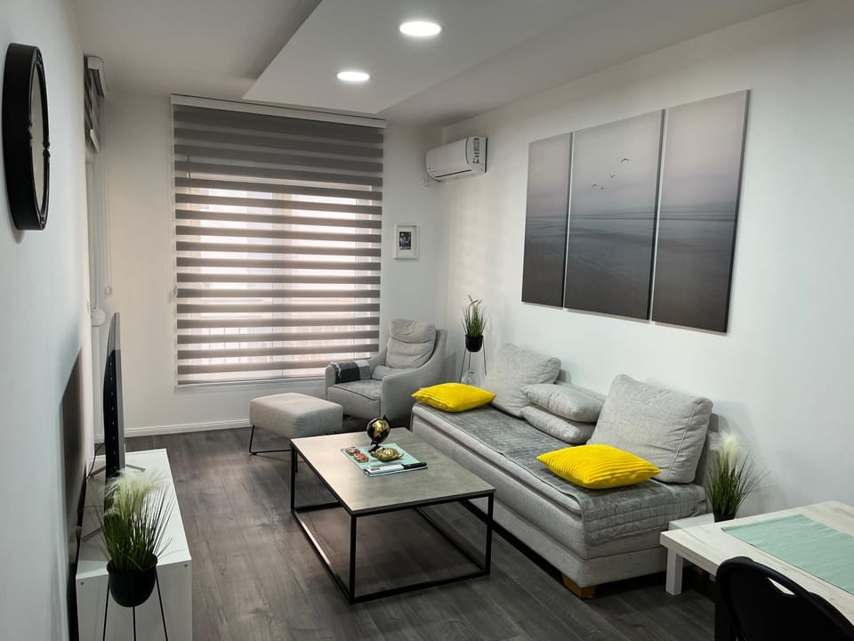Bed, TV and multimedia, Living room, Seating area, air conditioner