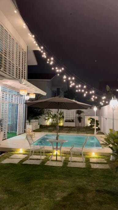 Property building, Patio, Night, BBQ facilities, Garden, Garden view, Pool view, Swimming pool, sunbed