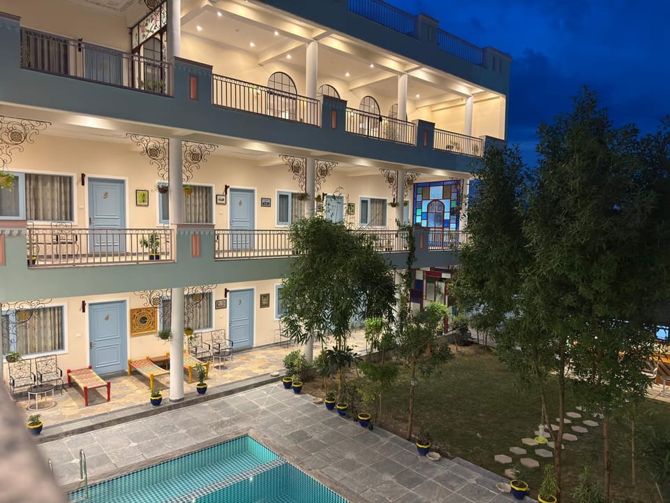 Property building, Patio, Night, View (from property/room), Balcony/Terrace, Evening entertainment, Pool view, Swimming pool