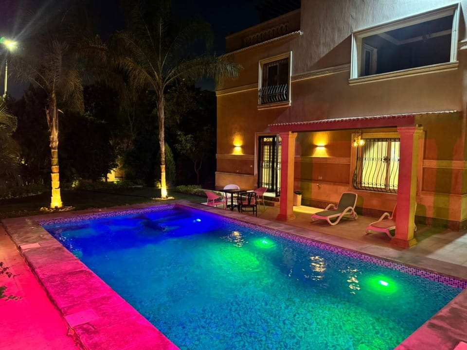 Property building, Patio, Night, Pool view, Swimming pool, sunbed