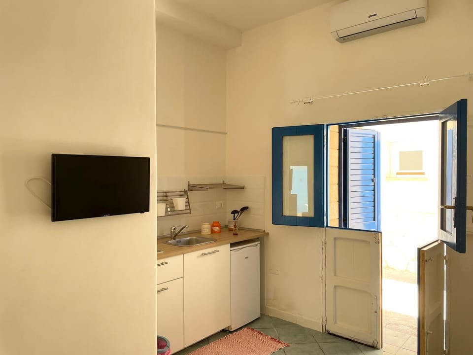 Kitchen or kitchenette, stove, air conditioner