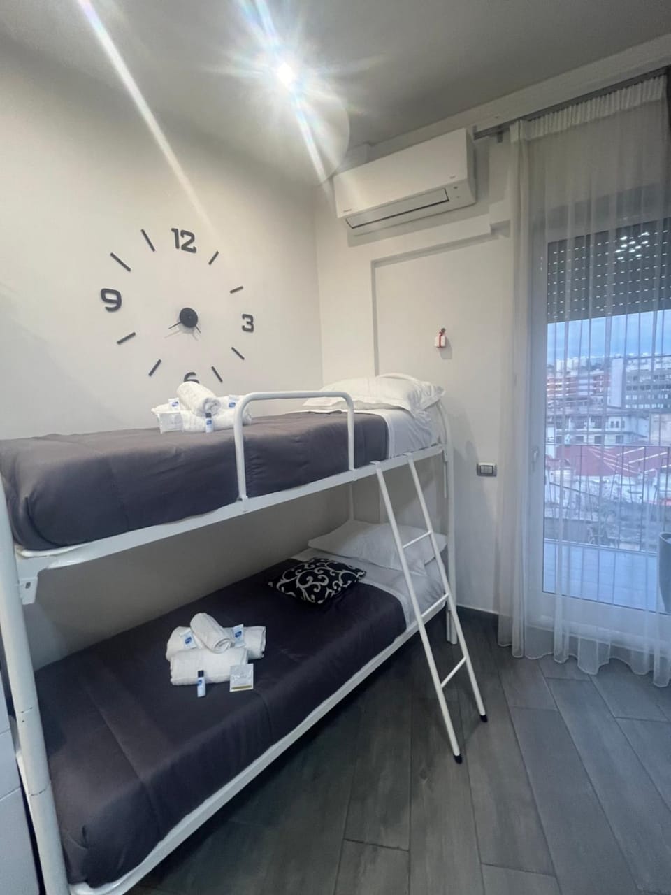 Photo of the whole room, bunk bed, towels, air conditioner
