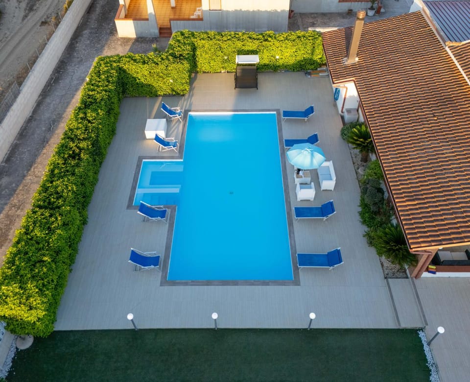 Property building, Patio, Pool view, Swimming pool, sunbed