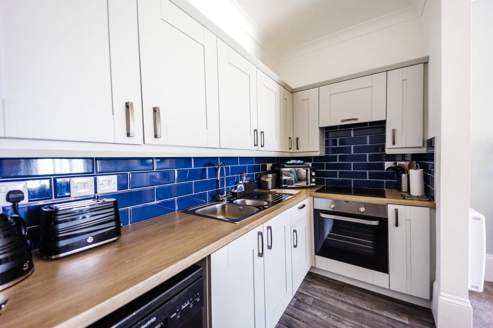 Kitchen or kitchenette, dishwasher, oven, stove, toaster