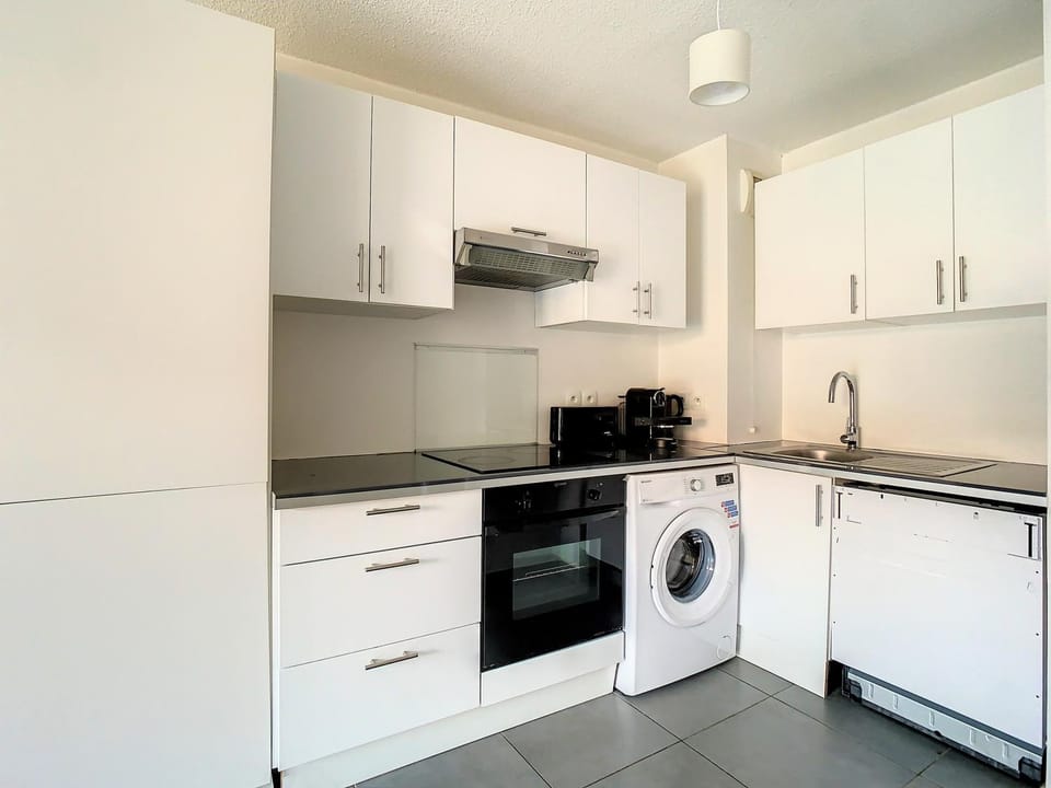 Kitchen or kitchenette, dishwasher, stove, toaster, washing machine