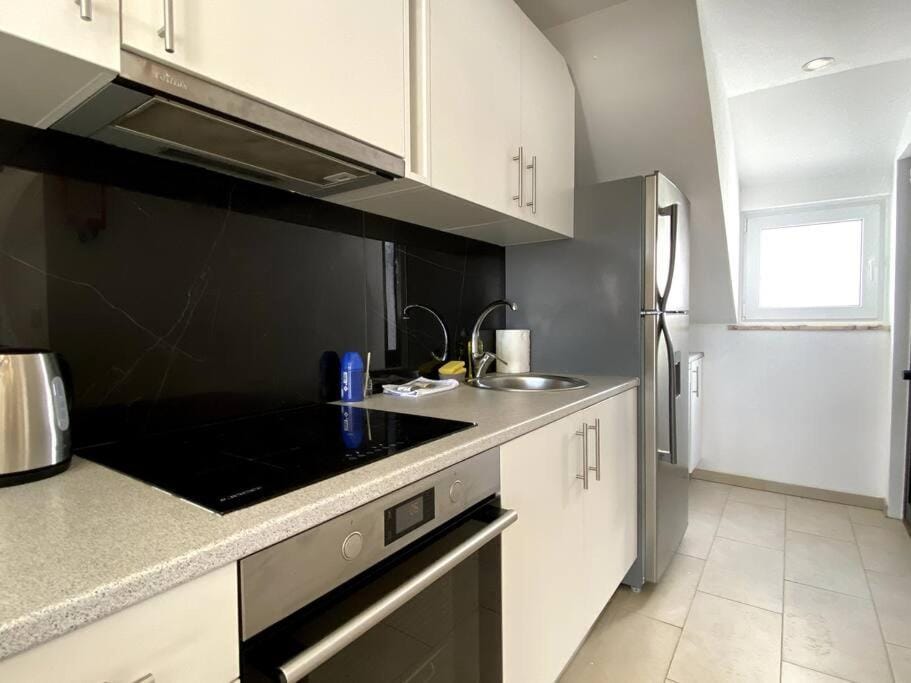 Kitchen or kitchenette, dishwasher, oven, stove, toaster