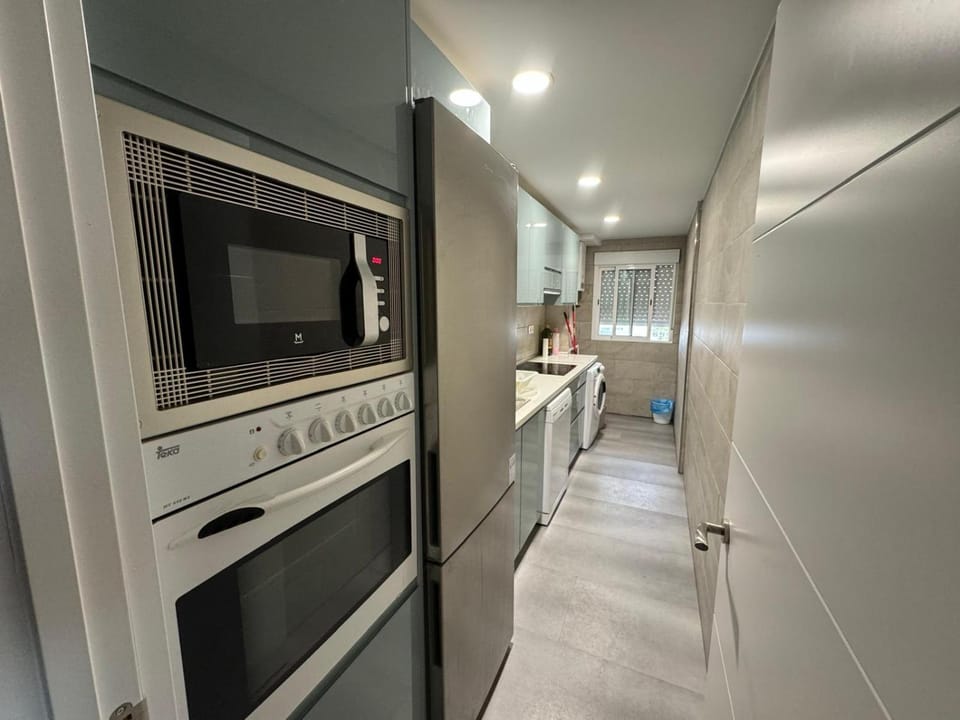 Kitchen or kitchenette, dishwasher, oven, stove