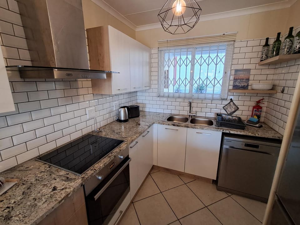 Kitchen or kitchenette, dishwasher, oven, stove