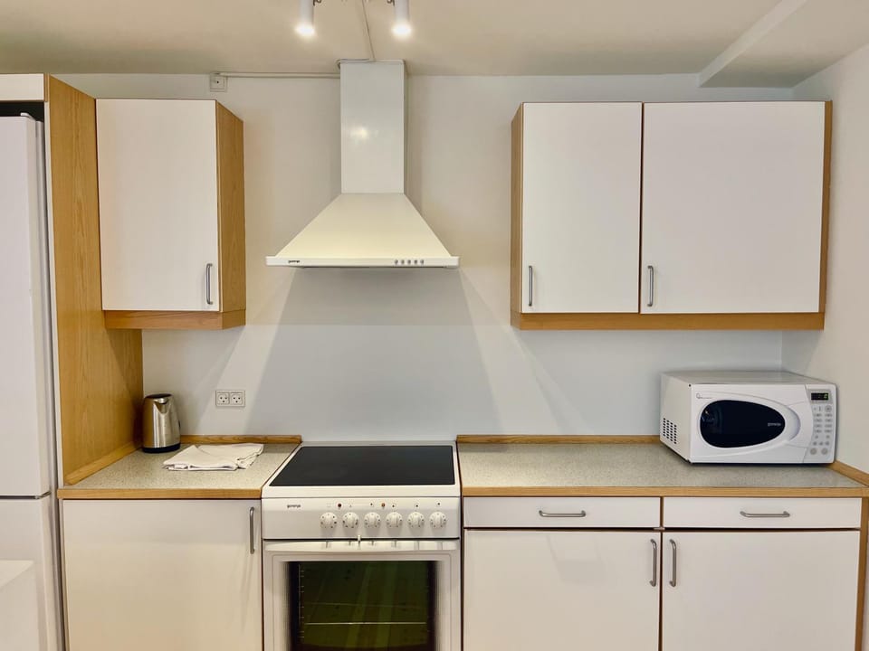Kitchen or kitchenette, microwave, oven, stove