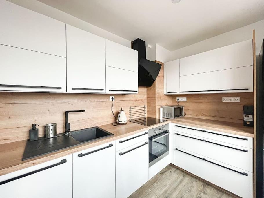 Kitchen or kitchenette, dishwasher, oven, stove
