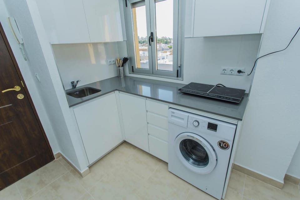 Kitchen or kitchenette, stove, washing machine