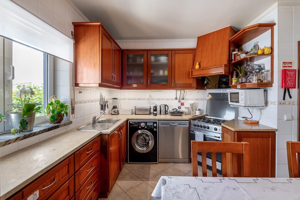 Kitchen or kitchenette, dishwasher, oven, stove, toaster, washing machine