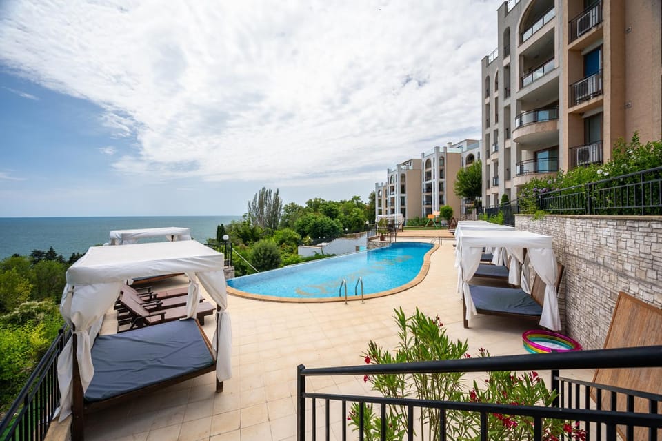 Property building, Patio, Day, Natural landscape, Garden, View (from property/room), Balcony/Terrace, Seating area, On site, Pool view, Sea view, Area and facilities, Swimming pool, group of guests, Family, sunbed