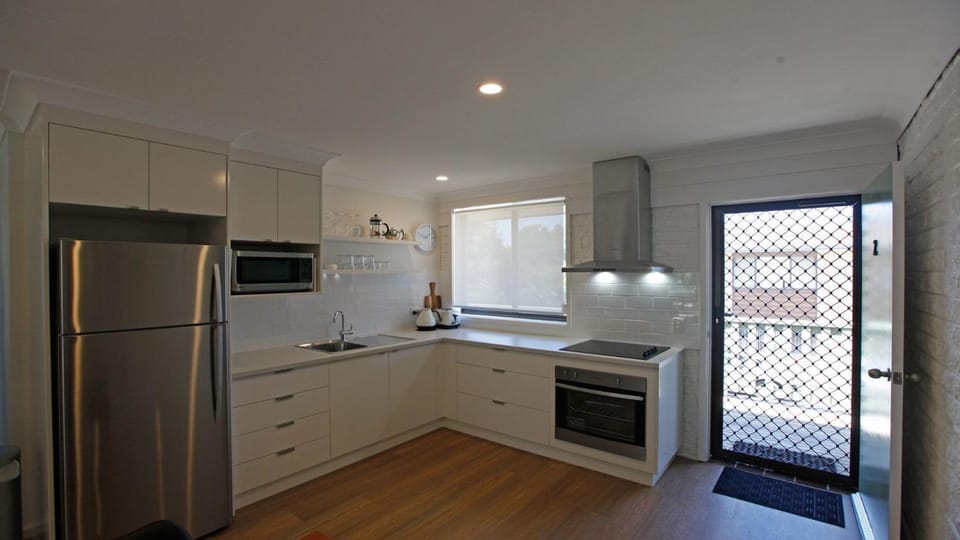 Kitchen or kitchenette, microwave, oven, stove