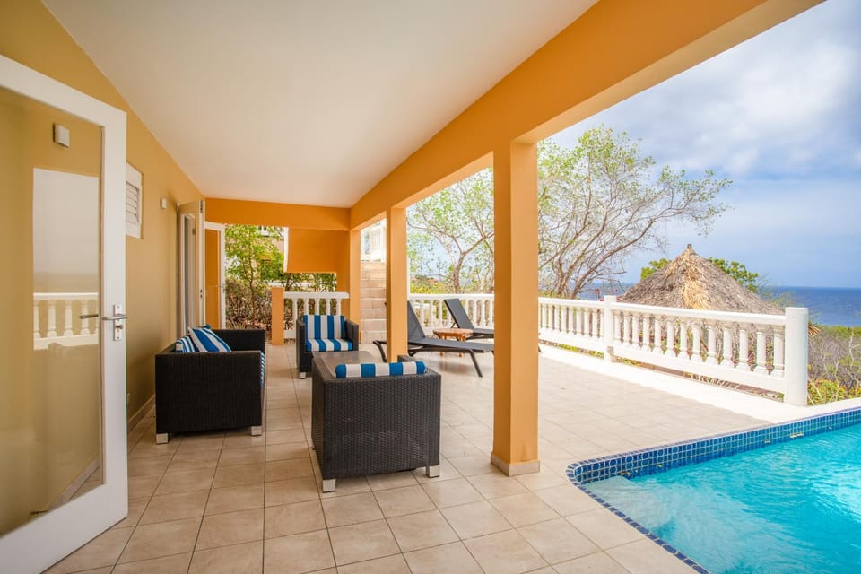 View (from property/room), Balcony/Terrace, Seating area, Sea view, Swimming pool, sunbed