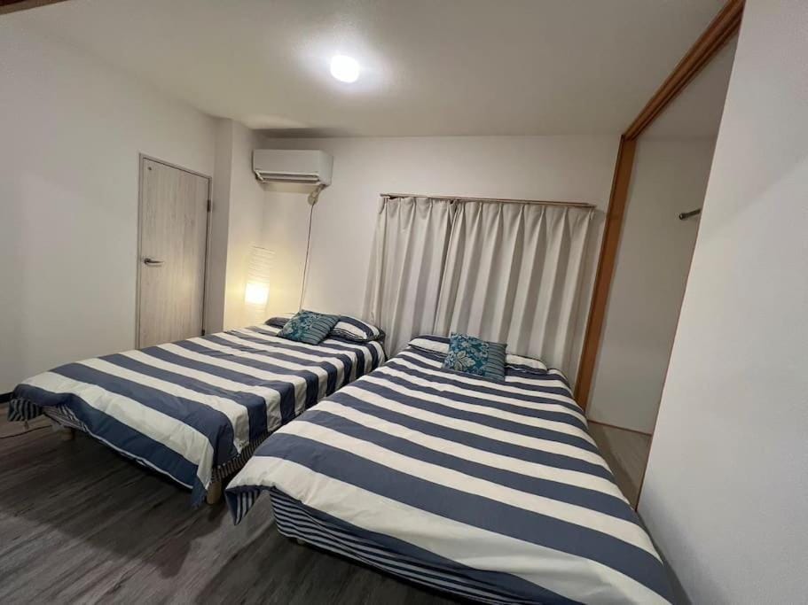 Large two separated rooms with 5 beds in the Osaka Apartment in Osaka
