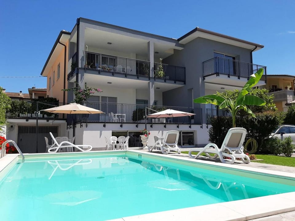 Property building, Day, Pool view, Swimming pool, sunbed