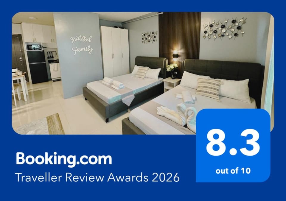 Bed, Property logo or sign, Photo of the whole room, Logo/Certificate/Sign, Bedroom, Text overlay, Certificate/Award, towels