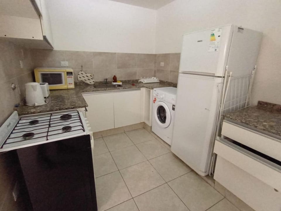 Kitchen or kitchenette, oven, toaster, washing machine