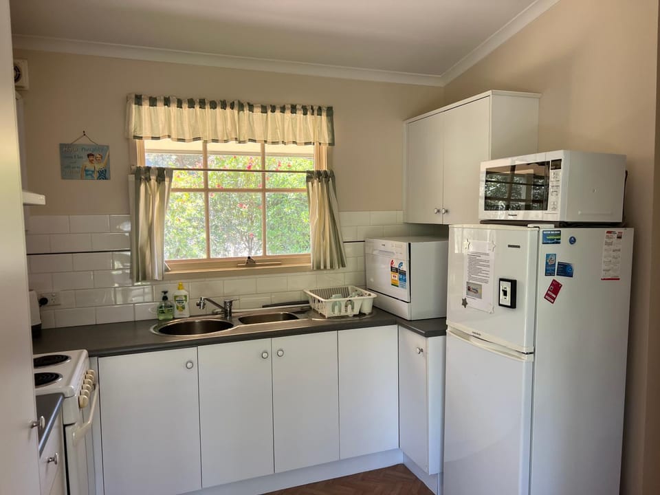 Kitchen or kitchenette, dishwasher, oven, stove