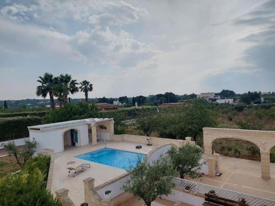 Property building, Day, Natural landscape, Pool view, Swimming pool, Swimming pool, sunbed