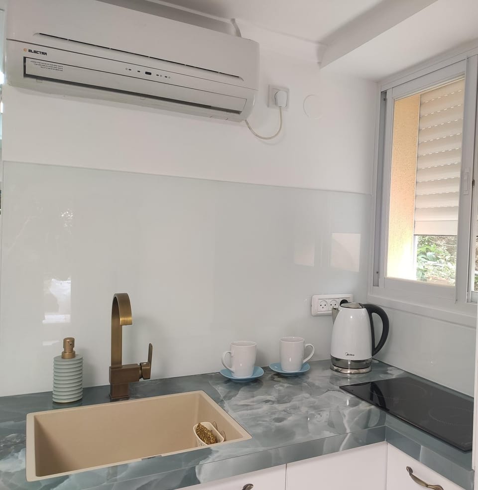 Kitchen or kitchenette, stove, air conditioner