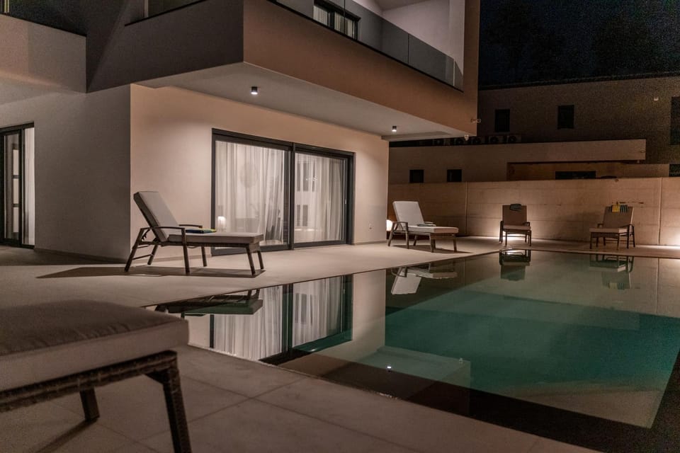 Patio, Night, Seating area, Pool view, Swimming pool, sunbed