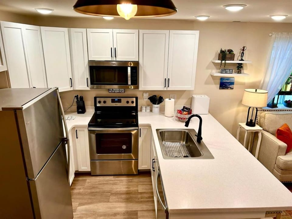 Kitchen or kitchenette, dishwasher, microwave, oven, stove