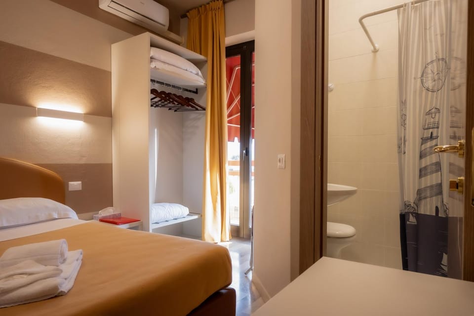Shower, Toilet, Bed, towels, wardrobe, air conditioner