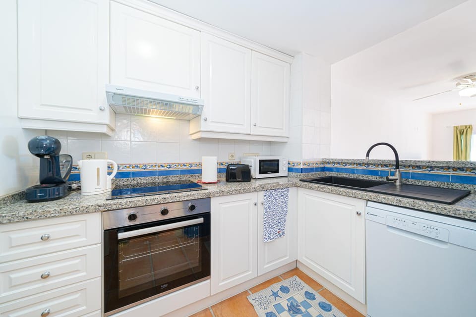 Kitchen or kitchenette, dishwasher, oven, stove