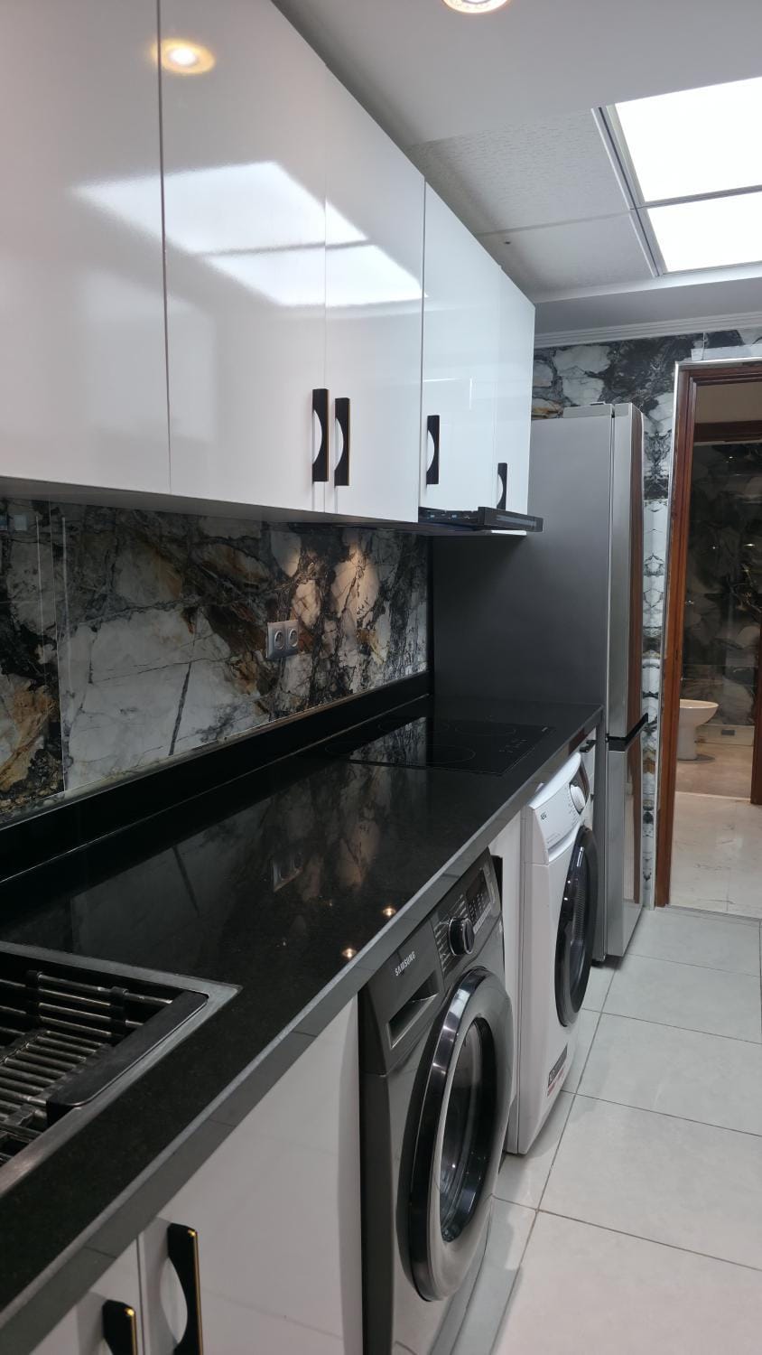 Kitchen or kitchenette, stove, washing machine, dryer